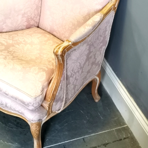 214 - French style salon chair, limed oak frame with carved decoration, upholstered in a pink damask, in u... 