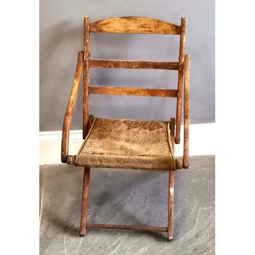 216 - Antique folding campaign chair with carpet seat, needing attention, in original condition, 47 cm wid... 