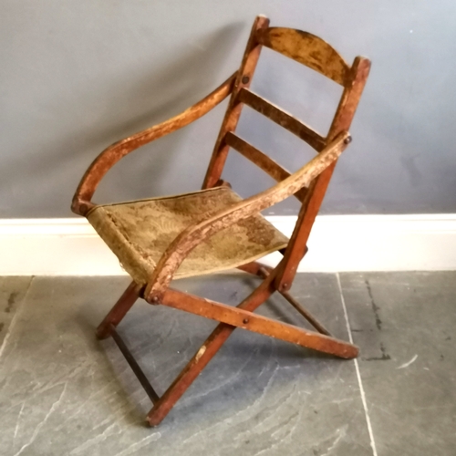 216 - Antique folding campaign chair with carpet seat, needing attention, in original condition, 47 cm wid... 