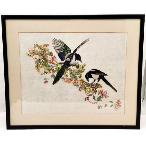 231 - Framed needlework picture of a pair of Magpie's 77 cm wide, 64 high, to include frame.