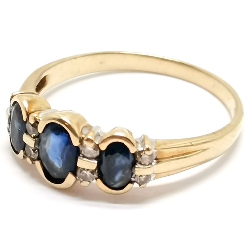 309 - 9ct marked gold sapphire (3) and diamond (8) ring in rub over mount ~ size Q & 2.3g total weight