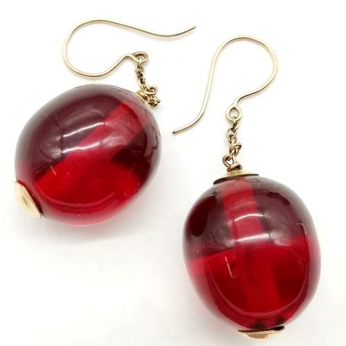 331 - Pair of red amber bead earrings with unmarked gold mounts bead approx 2.5cm across ~ 6cm drop & 15.5... 