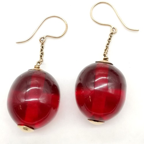 331 - Pair of red amber bead earrings with unmarked gold mounts bead approx 2.5cm across ~ 6cm drop & 15.5... 