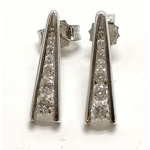 325 - 18ct hallmarked white gold pair of earrings channel set with graduated diamonds (14 in total) by AOU... 