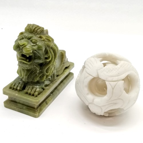 246 - Carved green stone statue of a recumbent lion (15cm x 12cm high) t/w Oriental carved hardstone conce... 