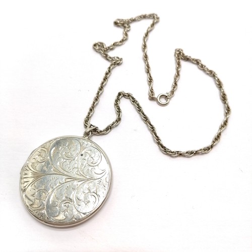 435 - Large silver locket with engraved detail to front (4cm) on a silver 44cm chain - total weight 26g ~ ... 