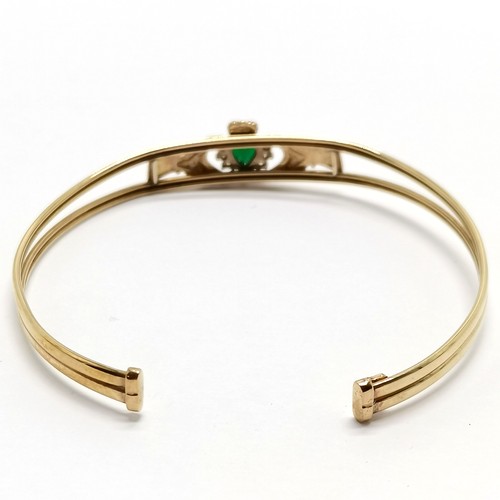 524 - 9ct hallmarked gold claddagh bangle set with heart shaped emerald & white stones (1 missing) - 5.2g ... 