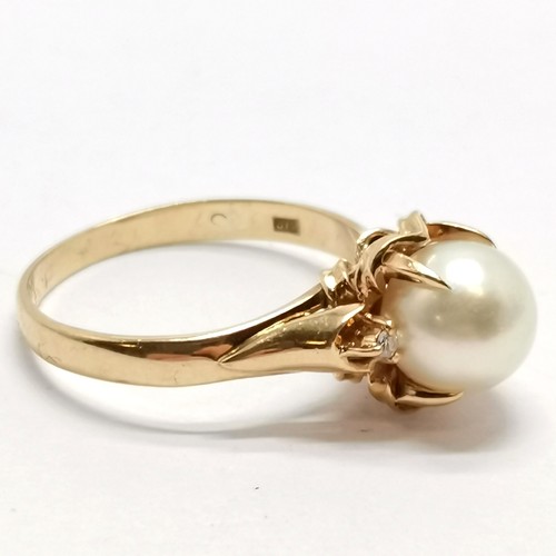 575 - 18ct marked gold pearl set ring with diamond set shoulders - size N & 3.8g total weight