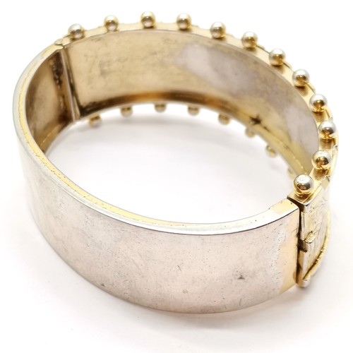 591 - Antique sterling silver gilt bangle with engraved decoration and ball detail to front - 6.5cm across... 