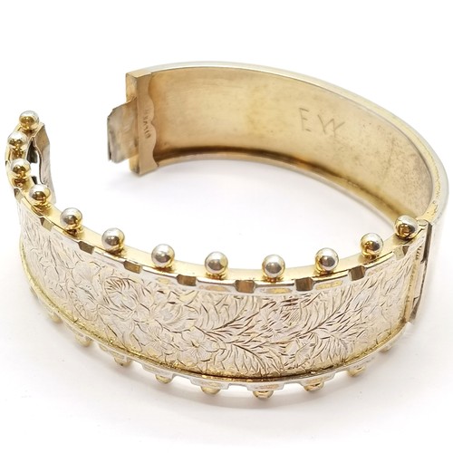 591 - Antique sterling silver gilt bangle with engraved decoration and ball detail to front - 6.5cm across... 