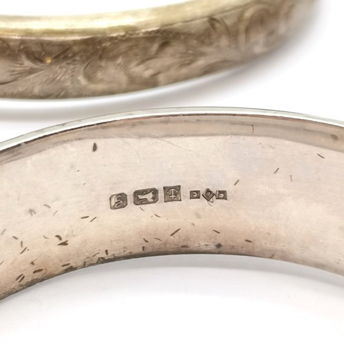 593 - 3 x silver hallmarked bangles - all with engraved detail ~ 64g ~ slight dents to 1 bangle