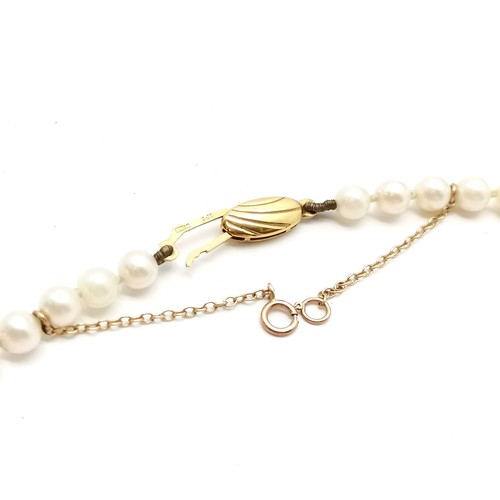 671 - 44cm strand of cultured pearls (approx 5mm diameter) with 9ct gold clasp in a retail box