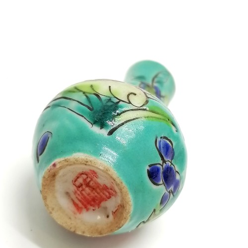 37 - Chinese miniature vase with floral decoration on a blue green ground - 5cm high