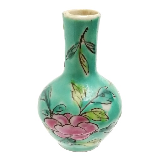 37 - Chinese miniature vase with floral decoration on a blue green ground - 5cm high