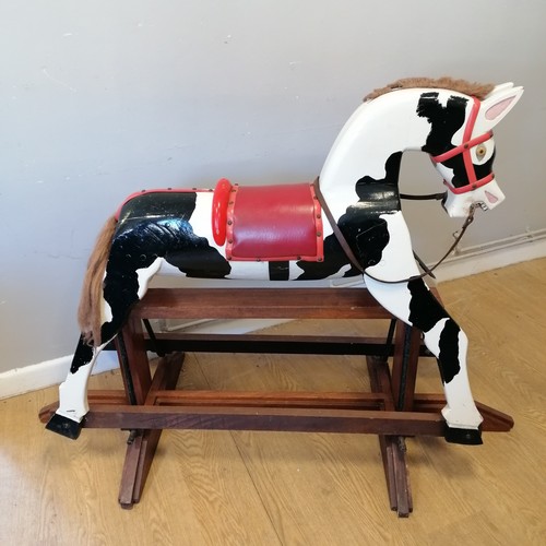 86 - Peter the Piebald rocking horse on mahogany base with vinyl saddle, in good used condition 145cm lon... 