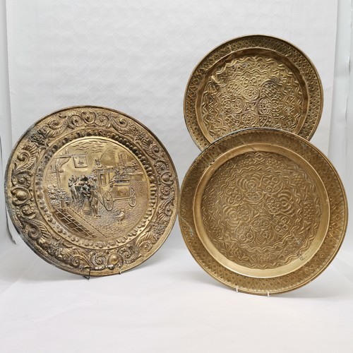 89 - Pair of circular brass wall chargers 45cm diameter T/W a pictorial circular wall charger 56cm diamet... 