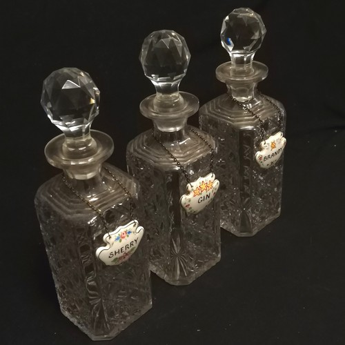 157 - Set of 3 cut glass crystal decanters 28cm high with porcelain Gin, Brandy and Sherry labels - slight... 