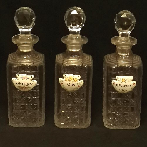 157 - Set of 3 cut glass crystal decanters 28cm high with porcelain Gin, Brandy and Sherry labels - slight... 