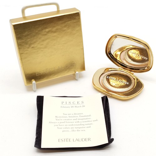 184 - Estee Lauder Pisces gold tone powder compact in original retail packaging - in unused condition but ... 