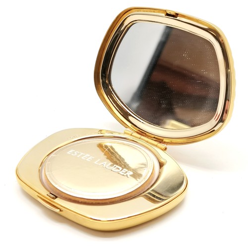 184 - Estee Lauder Pisces gold tone powder compact in original retail packaging - in unused condition but ... 