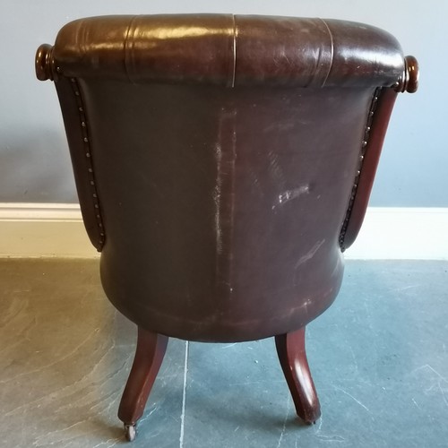 199 - Antique mahogany framed leather upholstered button back library chair, with scroll arms in good cond... 