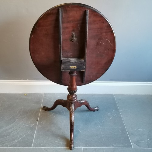 207 - Antique mahogany tilt top occasional table on turned and reeded column terminating on carved tripod ... 