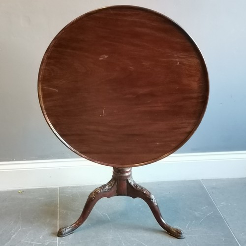 207 - Antique mahogany tilt top occasional table on turned and reeded column terminating on carved tripod ... 