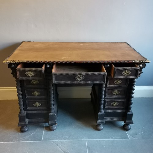 210 - Antique ebonised pedestal leather top writing desk with carved and brass fretwork decoration, turned... 