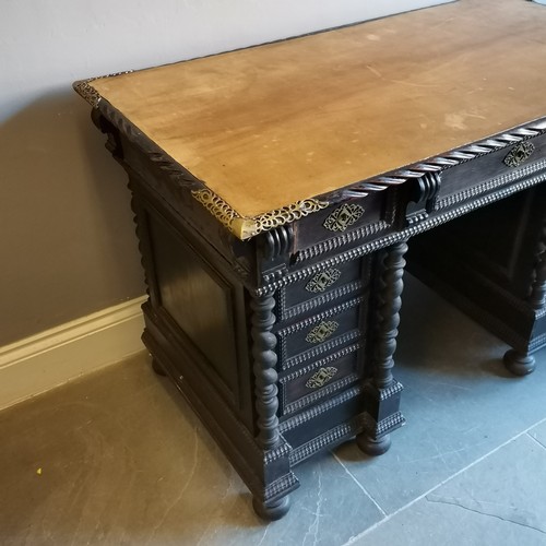 210 - Antique ebonised pedestal leather top writing desk with carved and brass fretwork decoration, turned... 