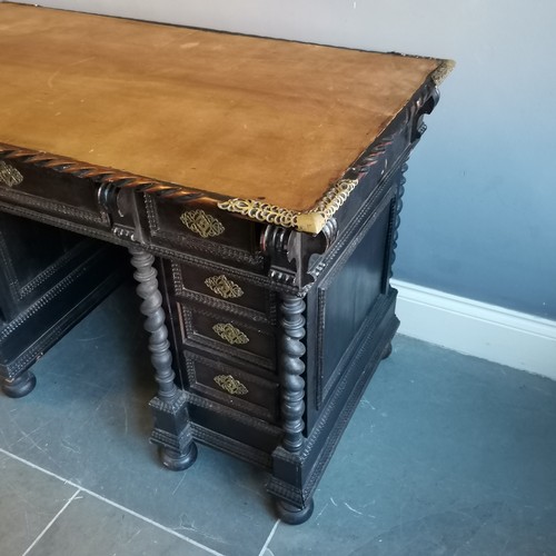 210 - Antique ebonised pedestal leather top writing desk with carved and brass fretwork decoration, turned... 