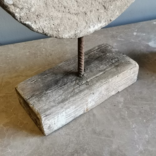 212 - Matched pair of sandstone mill stones mounted on a iron rod and driftwood bases, 32 cm wide, 11 cm d... 