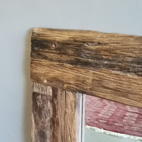 225 - Driftwood bevelled edged framed mirror measuring 100cm wide x 120cm high. In good condition.