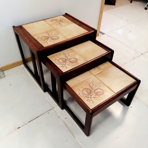 318 - Mid Century Teak Nest of 3 tables with tiled tops decorated with horse chestnuts, largest 55 cm wide... 