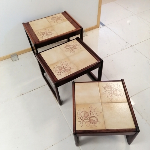 318 - Mid Century Teak Nest of 3 tables with tiled tops decorated with horse chestnuts, largest 55 cm wide... 