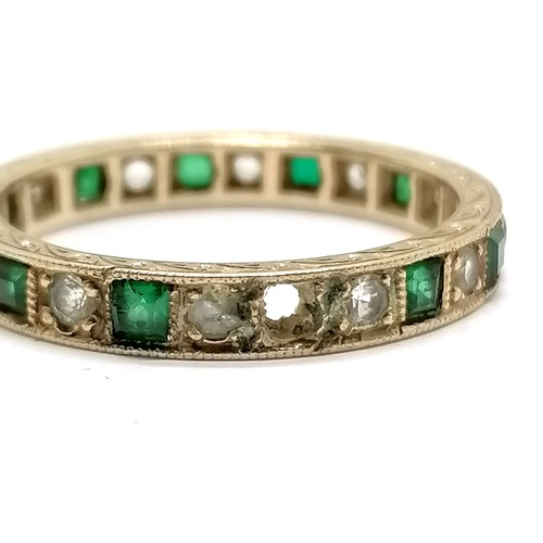 566 - 2 x gold stone set eternity rings (1 unmarked) - size P & T and total weight (2) 5g ~ the green ston... 