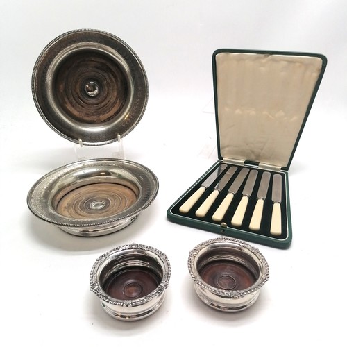 204 - Antique pair of silver plated coasters with engraved detail on turned wooden bases (20cm diameter), ... 