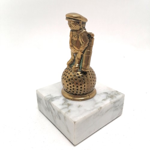223 - Tubal Cain products brass mascot of a golfer mounted on a white marble base - 12cm high