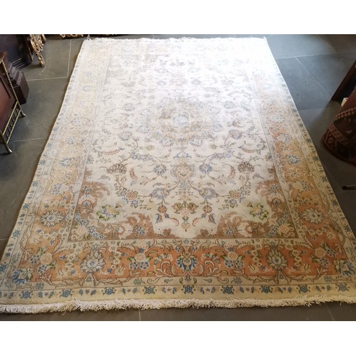 Large cream ground rug with central floral medallion within floral ...