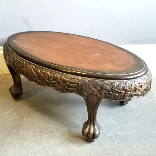 47 - Oriental hand carved oval coffee table on 4 claw feet - 80cm x 44cm x 31cm high ~ in used condition