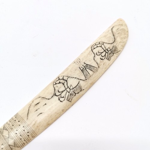 80 - Inuit scrimshaw carved bone scraping knife with carabou & tent detail - 24cm long