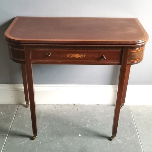 103 - Reproduction mahogany fold over card table with inlaid & marquetry drawer terminating on 4 brass cas... 