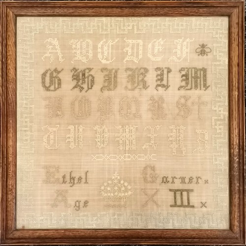 115 - Antique oak framed Alphabet sampler by Ethel Garner aged 13, 46cm square, colours slightly faded but... 