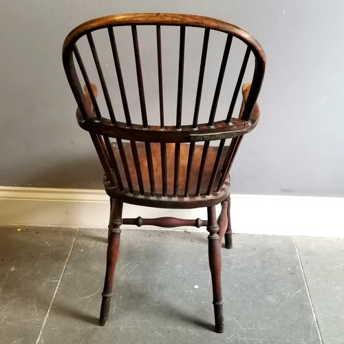 117 - Antique Windsor Elm bow back carver chair, 57cm wide x 42cm deep x 105cm high, split to seat and has... 