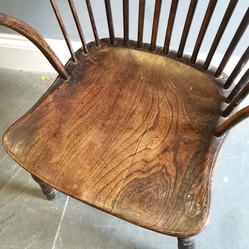 117 - Antique Windsor Elm bow back carver chair, 57cm wide x 42cm deep x 105cm high, split to seat and has... 