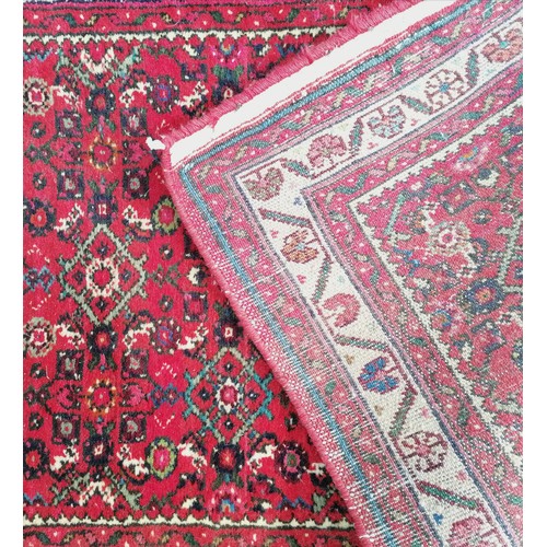 366 - Persian red grounded hand woven wool rug / runner - 412cm x 80cm ~ has mark to 1 part otherwise in g... 