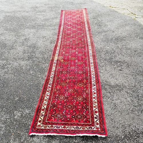 366 - Persian red grounded hand woven wool rug / runner - 412cm x 80cm ~ has mark to 1 part otherwise in g... 