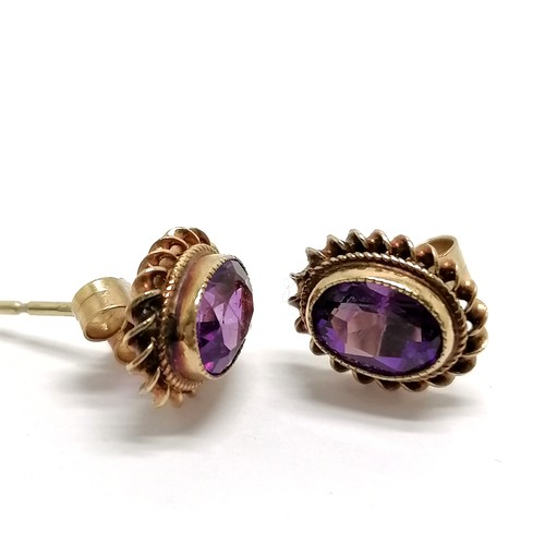 444 - 9ct hallmarked gold amethyst stone set earrings with rope twist border - approx 10mm across & 1.6g t... 