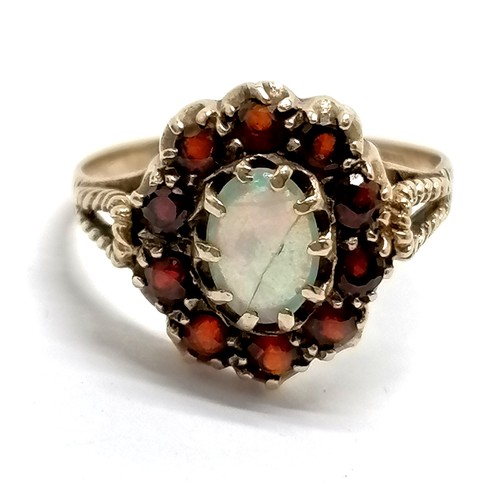 451 - 9ct hallmarked gold opal & garnet cluster ring - size R & 3.1g total weight ~ the opal has a crack