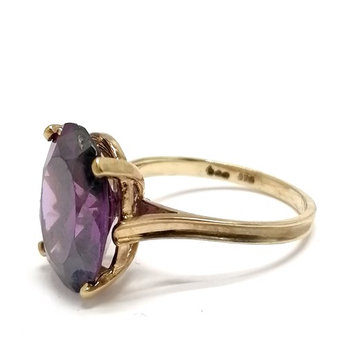 465 - 9ct marked gold purple stone set ring - size Q & 5.6g total weight