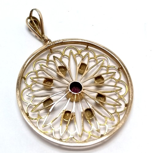 502 - 9ct marked gold circular pierced detail pendant set with garnet & pearls - 4.5cm drop & 3.1g total w... 